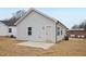Exterior view of a house with light gray siding and concrete patio at 815 Graham St, Burlington, NC 27217