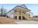 Charming home with a welcoming covered front porch and natural wood stairs at 815 Graham St, Burlington, NC 27217