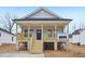 Lovely home with a raised porch and natural wood stairs, set against light gray siding at 815 Graham St, Burlington, NC 27217