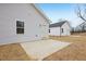 View of a house exterior with light gray siding and a concrete patio at 815 Graham St, Burlington, NC 27217