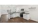 Bright kitchen features stainless appliances, white cabinets and modern finishes at 815 Graham St, Burlington, NC 27217