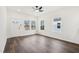 Open living room with vinyl floors, natural light, and a ceiling fan at 815 Graham St, Burlington, NC 27217