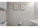 Half bathroom featuring a modern toilet, sink, and neutral-toned walls at 905 Arnold Place Dr, Fuquay Varina, NC 27526