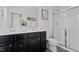 Bathroom with double sink vanity, dark wood cabinets, and shower with glass doors at 905 Arnold Place Dr, Fuquay Varina, NC 27526