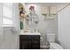 Modern bathroom featuring dark vanity, sleek fixtures, and decorative accents at 905 Arnold Place Dr, Fuquay Varina, NC 27526