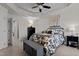 A primary bedroom showcasing a queen bed, a tray ceiling and a walk-in closet at 905 Arnold Place Dr, Fuquay Varina, NC 27526