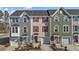 Charming townhomes featuring varied siding colors, attached garages, and well-maintained landscaping at 905 Arnold Place Dr, Fuquay Varina, NC 27526