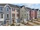 Townhome exteriors showcasing a cohesive design with varied colors, garages, and landscaping at 905 Arnold Place Dr, Fuquay Varina, NC 27526
