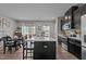Spacious kitchen featuring a large island, modern appliances, and open dining area at 905 Arnold Place Dr, Fuquay Varina, NC 27526