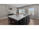 A kitchen featuring a dark island with a white countertop and stainless steel appliances at 905 Arnold Place Dr, Fuquay Varina, NC 27526