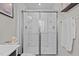 Modern shower with glass doors and chrome hardware at 905 Arnold Place Dr, Fuquay Varina, NC 27526