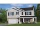 Charming two-story home with stone accents, black shutters, and a welcoming front porch at 912 Canis Minor Rd, Wendell, NC 27591