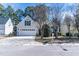 Charming home featuring a two-car garage, mature trees, and a well-maintained lawn at 9316 Erinsbrook Dr, Raleigh, NC 27617