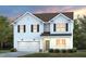 Charming two-story home with a two car garage and beautifully manicured front yard at 1003 Freestone Rd, Durham, NC 27703