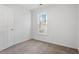 Bedroom featuring neutral carpet, a window with natural light, and white walls at 105 Solstice Cir, Cary, NC 27513