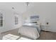 Serene bedroom with two windows, neutral paint and carpet, and a ceiling fan with light at 105 Solstice Cir, Cary, NC 27513