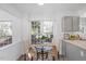 Cozy breakfast nook features a glass table, comfortable seating, and a lovely view through large windows at 105 Solstice Cir, Cary, NC 27513