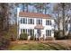 Classic two-story home with white siding, black shutters, and a meticulously maintained front lawn at 105 Solstice Cir, Cary, NC 27513