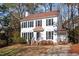 Traditional two-story home with manicured front yard, black shutters, and a red brick porch at 105 Solstice Cir, Cary, NC 27513