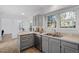 Bright kitchen features gray cabinets, stainless appliances, and a large window over the double sink at 105 Solstice Cir, Cary, NC 27513