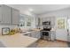 Modern kitchen with gray cabinetry, stainless steel appliances, and ample counter space at 105 Solstice Cir, Cary, NC 27513