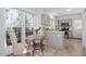 Sunlit kitchen with gray cabinets, stainless appliances, and a cozy breakfast nook at 105 Solstice Cir, Cary, NC 27513