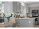 Well-lit kitchen featuring gray cabinets, stainless steel appliances, and countertop at 105 Solstice Cir, Cary, NC 27513