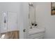 Compact powder room with a pedestal sink and decorative mirror, perfect for guests at 105 Solstice Cir, Cary, NC 27513