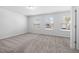 Bedroom with three windows, carpet flooring, and neutral paint at 1100 Freestone Rd, Durham, NC 27703