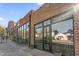 Exterior view of a brick building with tables and chairs for outdoor seating and a large storefront at 1241 S Blount Street # 201, Raleigh, NC 27601