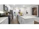 Bright kitchen with a large center island, white cabinetry, and stainless appliances at 1308 White Verona Way, Knightdale, NC 27545