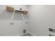 Bright laundry room offers built-in shelving for easy storage of supplies and linens at 1312 White Verona Way, Knightdale, NC 27545