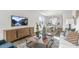 Open-concept living space featuring modern décor, a large TV, and plenty of natural light at 1312 White Verona Way, Knightdale, NC 27545
