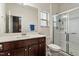 Bathroom featuring a glass-enclosed shower and a large vanity with ample counter space at 1610 Stone Rd, Durham, NC 27703