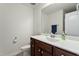 Bathroom featuring a wood cabinet vanity with modern sink, faucet, and mirror at 1610 Stone Rd, Durham, NC 27703