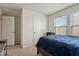 Bedroom featuring a comfortable bed, two windows, and neutral walls at 1610 Stone Rd, Durham, NC 27703