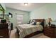 Comfortable bedroom featuring carpeted floors, a large bed, and ample natural light from a window at 1610 Stone Rd, Durham, NC 27703