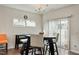 A dining area with a modern table and chairs, illuminated by a stylish chandelier at 1610 Stone Rd, Durham, NC 27703