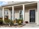 Inviting front porch with comfortable seating, attractive landscaping, and a secure Vivint security system at 1610 Stone Rd, Durham, NC 27703
