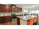 A view of the kitchen with stainless steel appliances, granite counters, and dark wood cabinets at 1610 Stone Rd, Durham, NC 27703