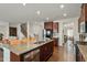 Open kitchen with a granite-topped island, stainless steel appliances, and direct access to the living areas at 1610 Stone Rd, Durham, NC 27703