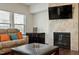 Cozy living room featuring a fireplace, comfortable seating, and a large screen television at 1610 Stone Rd, Durham, NC 27703