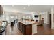 A stylish open-concept living room and kitchen area with a granite island, fireplace, and modern furnishings at 1610 Stone Rd, Durham, NC 27703