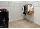 Walk-in closet featuring hanging racks for clothes and a carpeted floor, providing ample storage space at 1610 Stone Rd, Durham, NC 27703