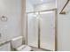 Bathroom featuring a white tile shower with sliding glass doors and brushed nickel hardware at 1749 Daiquiri Turn, Sanford, NC 27332