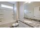 Bright bathroom features granite countertop, tile flooring and shower-tub combo at 1749 Daiquiri Turn, Sanford, NC 27332
