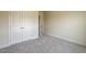 Neutral bedroom featuring carpeting and a double door closet with bright white trim throughout at 1749 Daiquiri Turn, Sanford, NC 27332