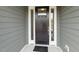 Inviting front door with sidelights, providing natural light and enhancing curb appeal of the home at 1749 Daiquiri Turn, Sanford, NC 27332