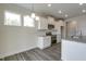 Bright kitchen features white cabinets, stainless steel appliances, and granite countertops at 1749 Daiquiri Turn, Sanford, NC 27332
