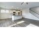 Bright kitchen features white cabinets, stainless steel appliances, island and staircase at 1749 Daiquiri Turn, Sanford, NC 27332